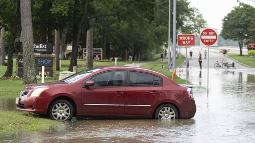 A stranded care is seen near the Lake Houston Bridge along West Lake Houston Parkway after it was closed due to high water on both sides of the roadway, Saturday, May 4, 2024, in Kingwood, Texas.  (Jason Fochtman/Houston Chronicle via AP)