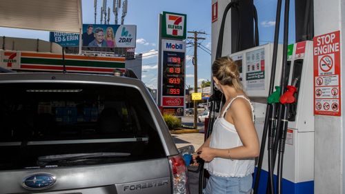 A woman fills up her car at the 7- Eleven in Rozelle, Sydney.