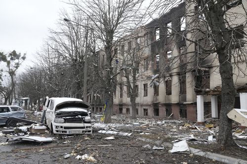 Damaged cars and a destroyed accommodation building are seen near a checkpoint in Brovary, outside Kyiv, Ukraine, Tuesday, March 1, 2022.