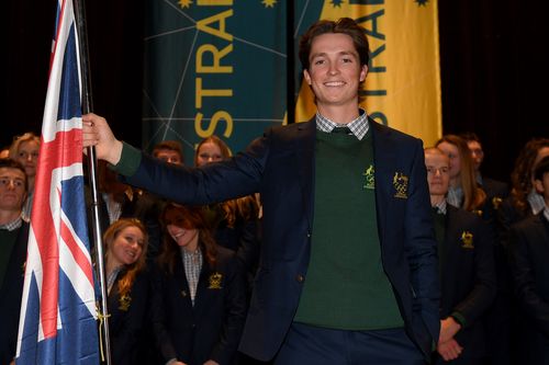 James poses for a photograph with the Australian flag after being announced as the team flag bearer. (AAP)