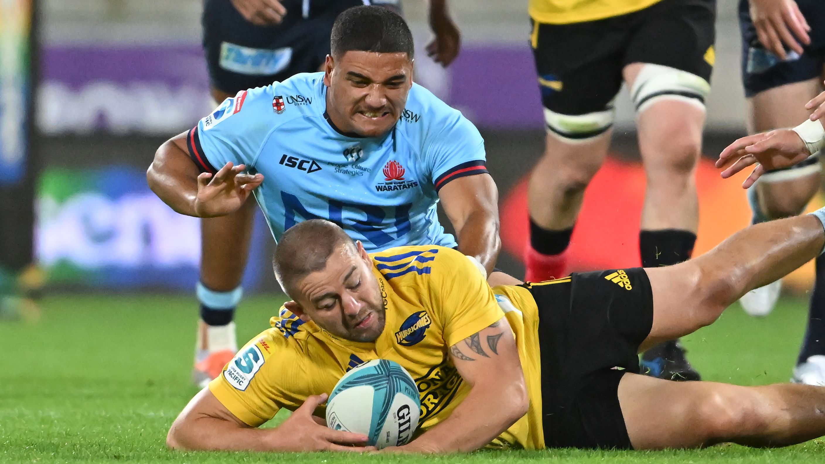 Dane Coles of the Hurricanes and Mosese Tuipulotu of the Waratahs compete for loose ball.