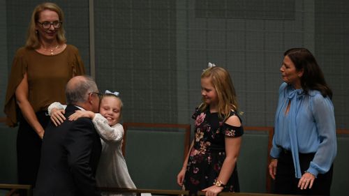 Mr Morrison is greeted by wife Jenny and daughters Abbey and Lily. (Picture: AAP)