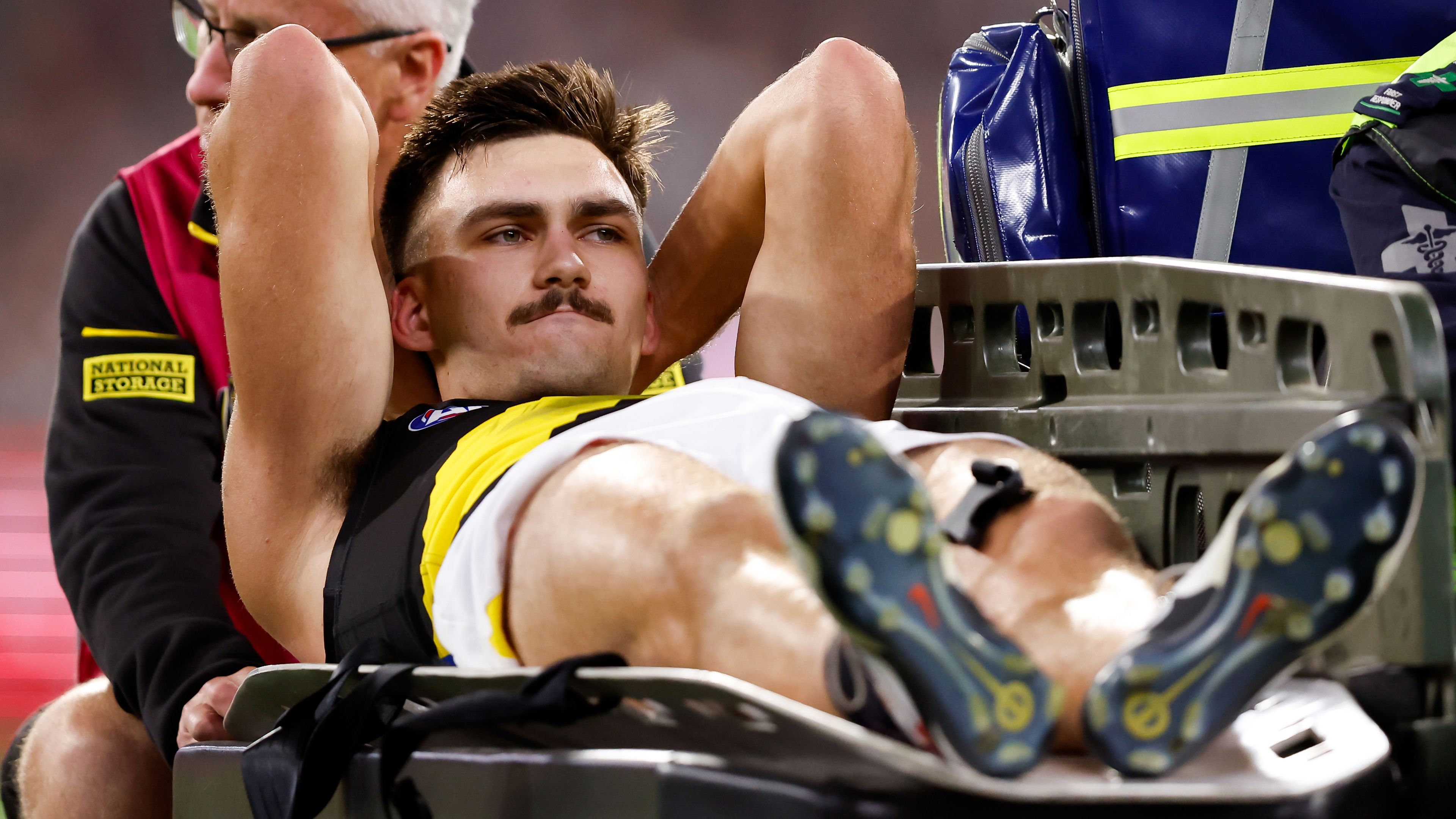 Josh Gibcus of the Tigers leaves the field on a stretcher during the 2024 AFL Round 01 match between the Carlton Blues and the Richmond Tigers at the Melbourne Cricket Ground on March 14, 2024 in Melbourne, Australia. (Photo by Dylan Burns/AFL Photos via Getty Images)