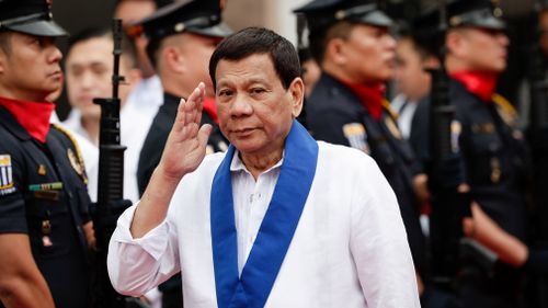 Philippine President Rodrigo Duterte reviews a honor guard at the Bureau of Customs in Manila, Philippines. (AAP)