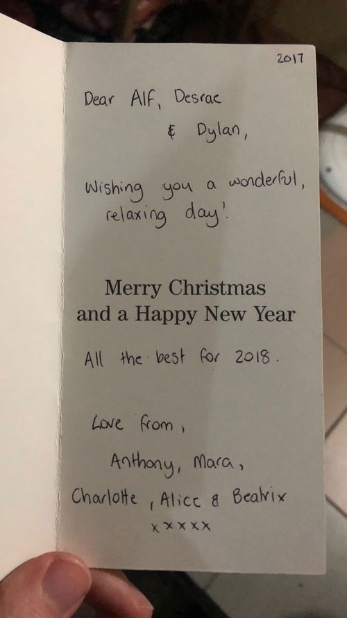 One man dashes inside to find a Christmas card from the family - he says they send one every year. 