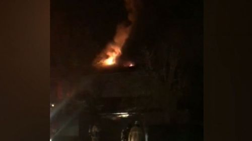 Neighbours said no one was home when the home was engulfed in flames. (9NEWS)