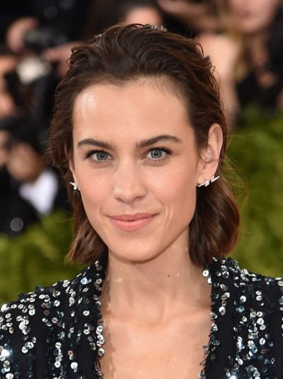 Alexa Chung's fresh-faced look matches the glistening iridescence of her dress - the slicked-back hair is different for her too.