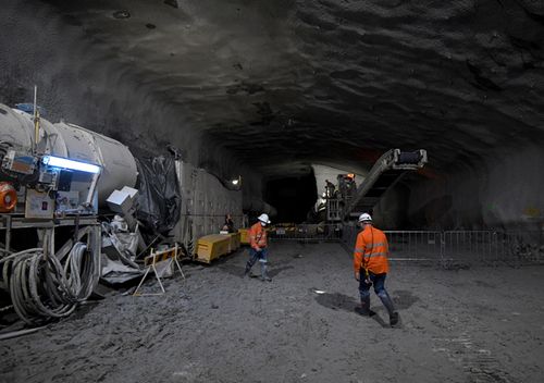 A roadheader and construction worker work on the eastbound WestConnex M4 tunnel at Concord in Sydney, June, 2017. (AAP)