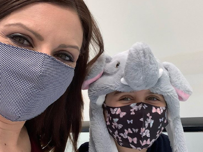 Jo Abi and her daughter wearing masks.