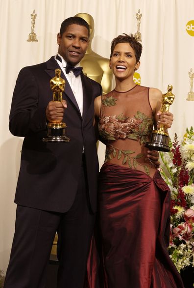 Actor and Actress in a Leading Role winners Denzel Washington and Halle Berry pose with their Oscars backstage in 2002.