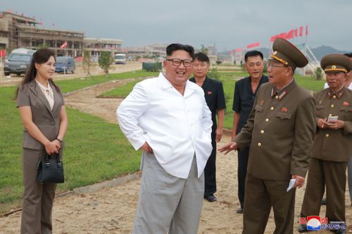 North Korean leader Kim Jong Un, accompanied by his wife Ri Sol Ju, visits a construction site in the Wonsan-Kalma coastal tourist area.