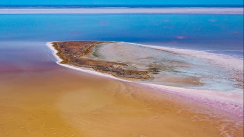 ï»¿Kati Thanda-Lake Eyre is a dry salt bed in the lowest point in Australia, sitting 15 metres below sea level, and covers about 9500 square kilometres.