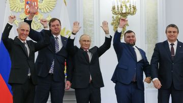 From left, Moscow-appointed head of Kherson Region Vladimir Saldo, Moscow-appointed head of Zaporizhzhia region Yevgeny Balitsky, Russian President Vladimir Putin, center, Denis Pushilin, the leader of the Donetsk People&#x27;s Republic and Leonid Pasechnik, leader of self-proclaimed Luhansk People&#x27;s Republic wave during a ceremony to sign the treaties for four regions of Ukraine to join Russia, at the Kremlin, Moscow, Friday, Sept. 30, 2022.  