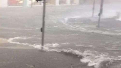 Water gushed along Brisbane streets and over the gutters. (Tobias Kelleher)