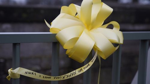 A yellow ribbon with a message of hope written on it, is tied to a bridge over the River Wyre in St Michael's on Wyre, Lancashire, as police continue their search for missing woman Nicola Bulley