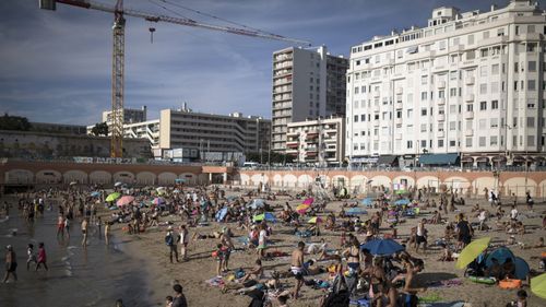 In this July 25, 2020, file photo, beachgoers enjoy the sun at the Plage des Catalans in Marseille, southern France.