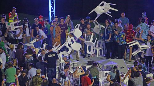 Crowd members throw chairs during the Invitational Darts Challenge at Etihad Stadium in Melbourne. (Getty)