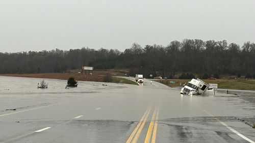 A tractor-trailer sits submerged in floodwater on US 63 north of Cabool, Missouri.