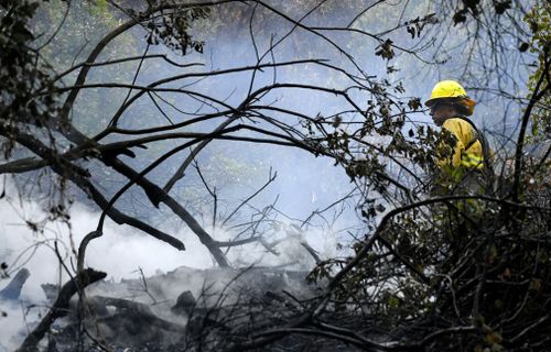  Several hundred firefighters worked to contain a blaze that chewed through brush-covered mountains, prompting evacuation orders for homes in Los Angeles, Burbank and Glendale. (Associated Press)