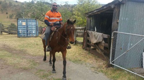 Mark Basa on prison work assignment working with therapy horses. (Supplied)