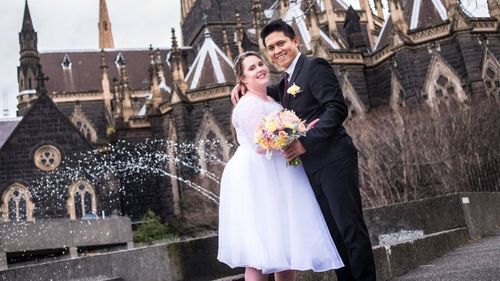 Mrs. Elliott and Mr. Domigo photographed on their wedding day.