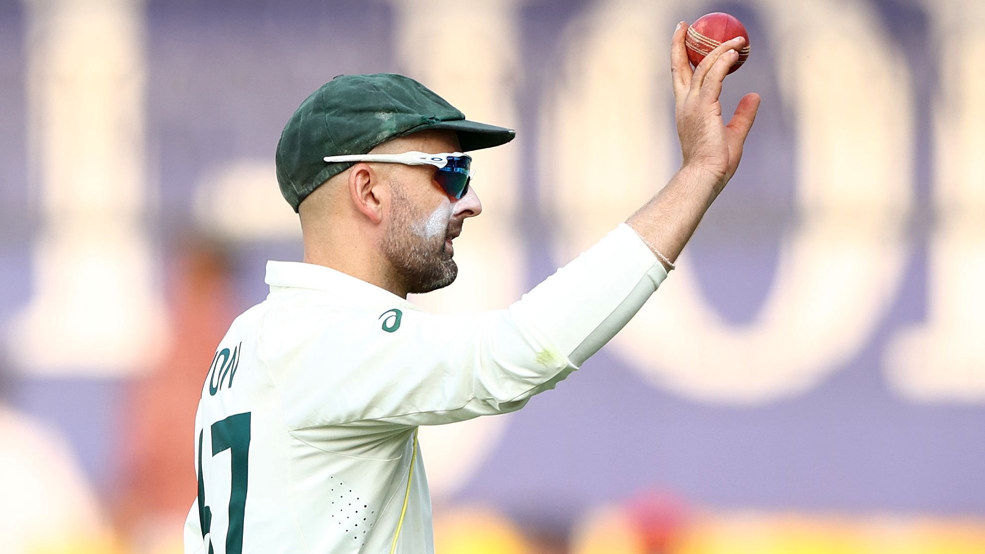 INDORE, INDIA - MARCH 02: Nathan Lyon of Australia holds up the ball after he took eight wickets in the second innings during day two of the Third Test match in the series between India and Australia at Holkare Cricket Stadium on March 02, 2023 in Indore, India. (Photo by Robert Cianflone/Getty Images)