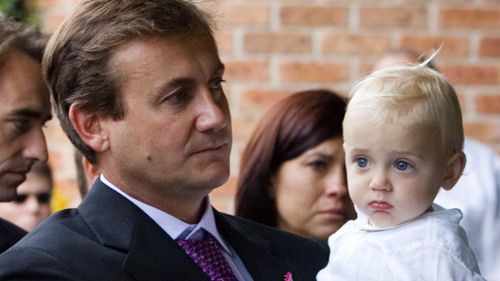 Greg McCann, pictured with baby son Cooper, at the athlete's funeral service in Wollongong in 2008. Picture: AAP