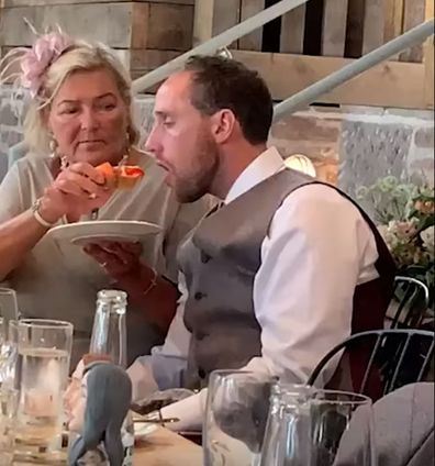 Drunk groom is hand-fed by mother-in-law at wedding