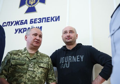 Arkady Bacbchenko has strolled into a press conference organised by Ukrainian authorities to discuss his supposed assassination. Babchenko is standing next to Vasily Gritsak, head of the Ukrainiian Security Service. Picture: AP