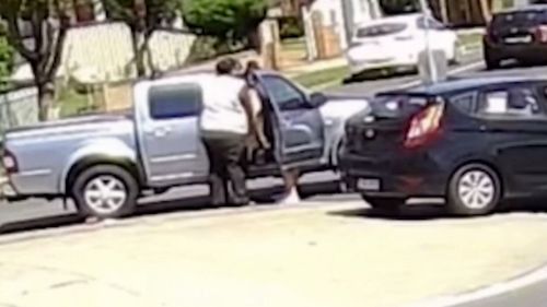 The pair then take swings at each other in the middle of the street.