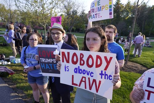 People protest outside a building on the campus of Saint Anselm College where a CNN televised town hall gathering with former President Donald Trump will be held, Wednesday, May 10, 2023, in Manchester, N.H. 