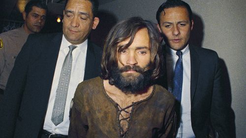 In this 1969 photo, Charles Manson is escorted to his arraignment on conspiracy-murder charges in connection with the Sharon Tate murder case. 