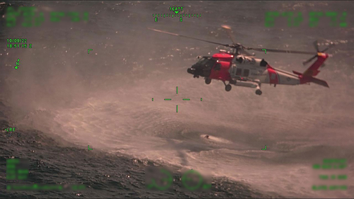 A Coast Guard Air Station New Orleans MH-60 Jayhawk hovers over their rescue swimmer during a rescue, approximately 25 miles offshore from Empire, Louisiana, on Oct. 9.