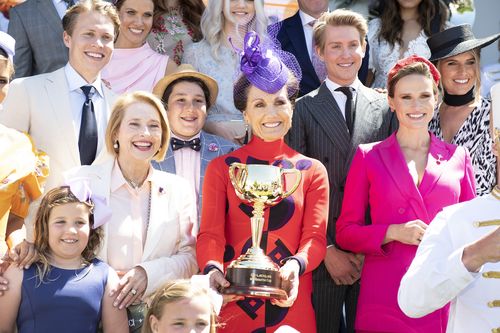 VRC Chairman Amanda Elliott (centre) with the Melbourne Cup, alongside racing royalty Gai Waterhouse (left).