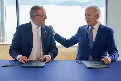 President Joe Biden, right, gestures to Australia's Prime Minister Anthony Albanese following a document signing ceremony on the sidelines of the G7 Summit in Hiroshima, Japan, Saturday, May 20, 2023 