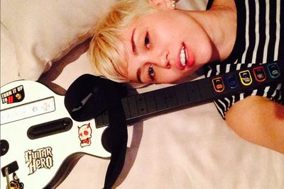 Miley gave the Grammys a miss after scoring no nominations for her album <i>Bangerz</i>. On Grammy night, Miley stayed home to play Guitar Hero. She teased fans with the caption: 'Video of tonight's performance <3'. Check out the vid on the next slide!