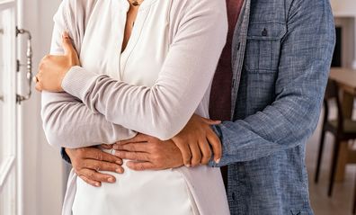 couple at home hugging