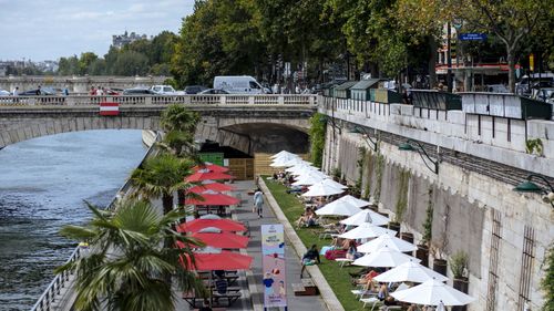 In this July 28, 2020, file photo, people enjoy the sun on deckchairs along the river Seine in Paris.