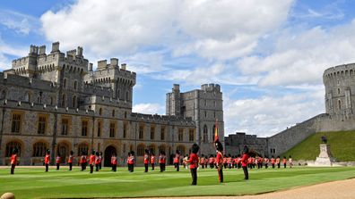 Guardsmen keep social distance as they stand in formation for a ceremony to mark Britain's Queen Elizabeth's official birthday at Windsor Castle on June 13, 2020 in Windsor, England