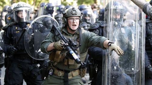 Police look to disperse protesters outside the White House.