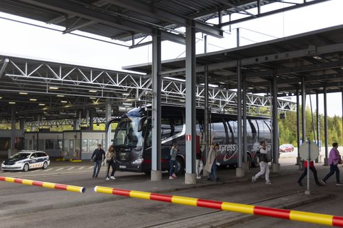 Russian passengers exit a bus to the passport control at the Vaalimaa border check point between Finland and Russia in Virolahti, Eastern Finland Wednesday, Sept. 28, 2022.  