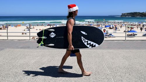 Another beachgoer soaking up what could be more summer sun ahead this Christmas. (AAP)