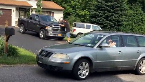 Michael Rotondo honked and waved to reporters as he pulled out of the driveway of his parents' split-level ranch in Camillus, New York. Picture: AP
