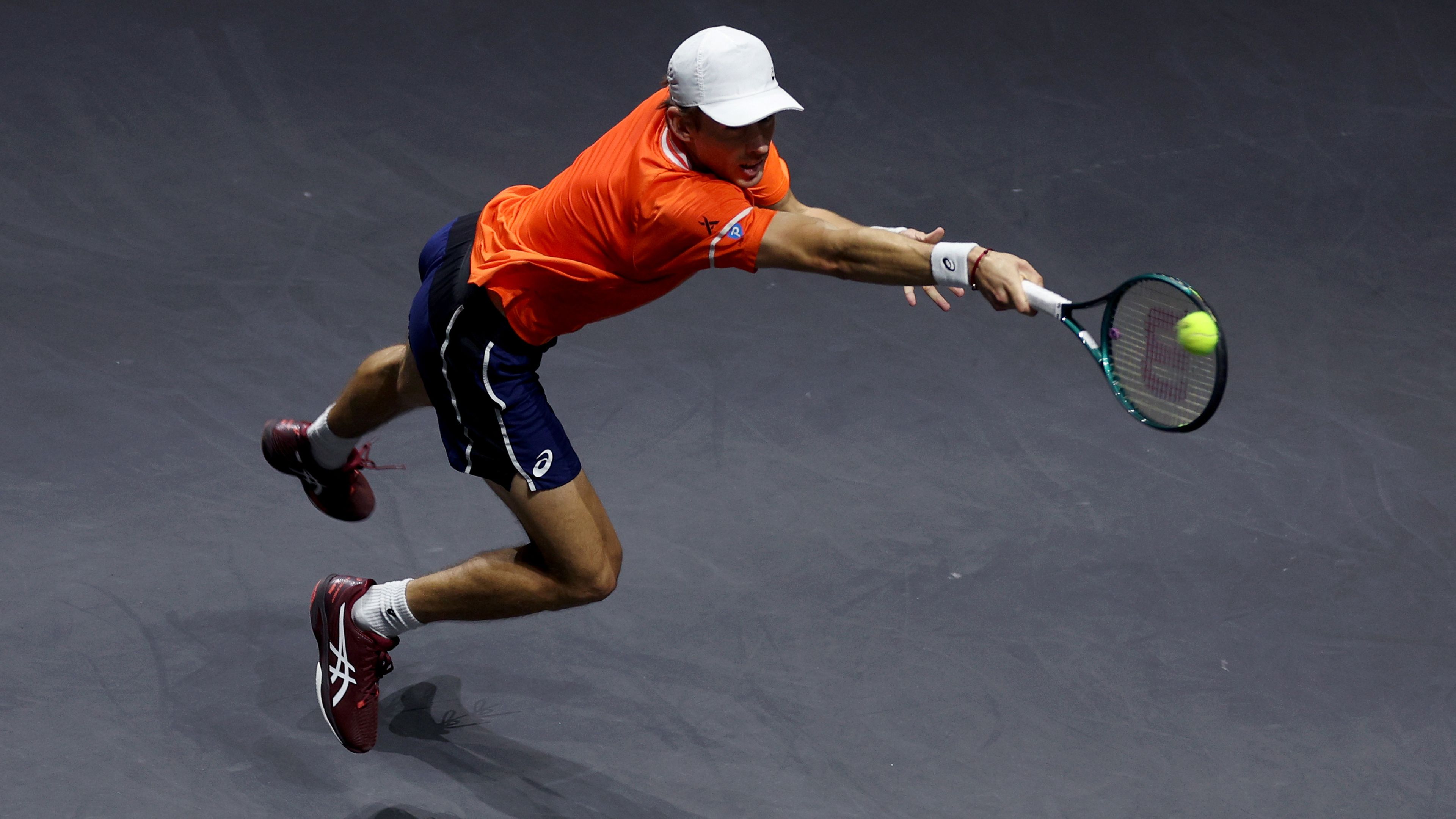 Alex de Minaur of Australia returns a backhand against Jannik Sinner of Italy.