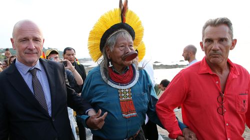 Kayapo tribal leader Raoni Metuktire holds hands with Emmanuel Alzuri, left, the mayor of Bidart and Marcos Foster, right, city councilor in Bidart, southwestern France, as they arrive for a press conference on Monday, Aug. 26, 2019. Raoni, the figurehead of the fight against deforestation in the Amazon, said that he met French President Emmanuel Macron on Monday evening after the G-7 summit ended in nearby Biarritz. 
