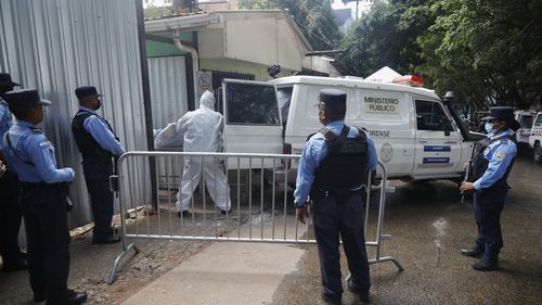 Forensic experts unload a body removed from a women's prison, at the medical morgue in Tegucigalpa, Honduras, Wednesday, June 21, 2023. 