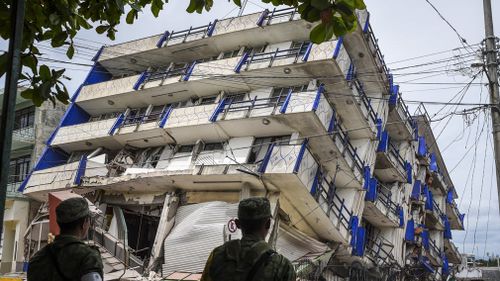 Soldiers stand guard a few metres away from the Sensacion hotel which collapsed with the powerful earthquake that struck Mexico overnight, in Matias Romero, Oaxaca State, on September 8, 2017. (AFP)