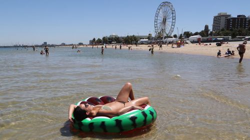 A beachgoer cools down at St Kilda in Melbourne. (AAP)