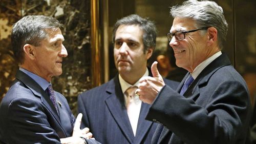 Michael Cohen (centre) chats with General Michael Flynn and former Texas governor Rick Perry. (AP)