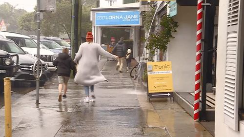 NSW residents run for cover on Sunday as a low brought heavy rain and wild winds to coastal areas.